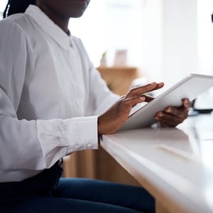 Female ABA provider using data collection on tablet in modern office
