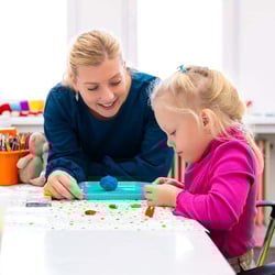 ABA provider with toddler girl in session doing sensory exercises