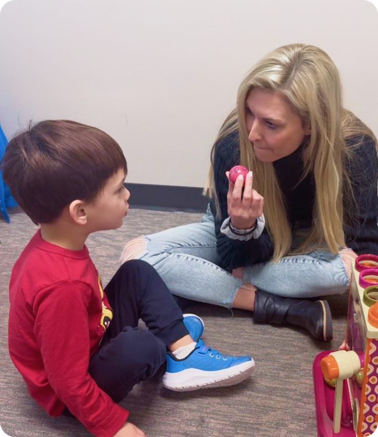 teacher-helping-child-with-learning-toy